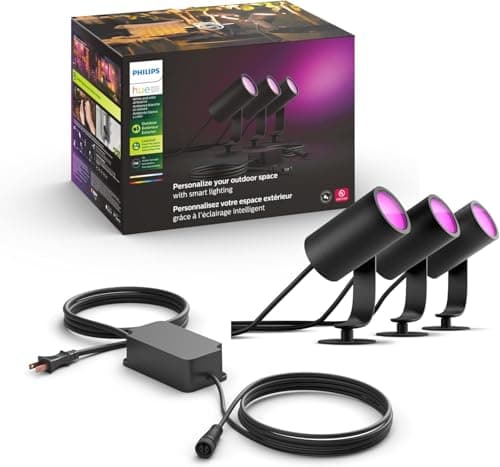 Philips Hue Lily Outdoor Smart Spotlight three-pack illuminating garden bed at night